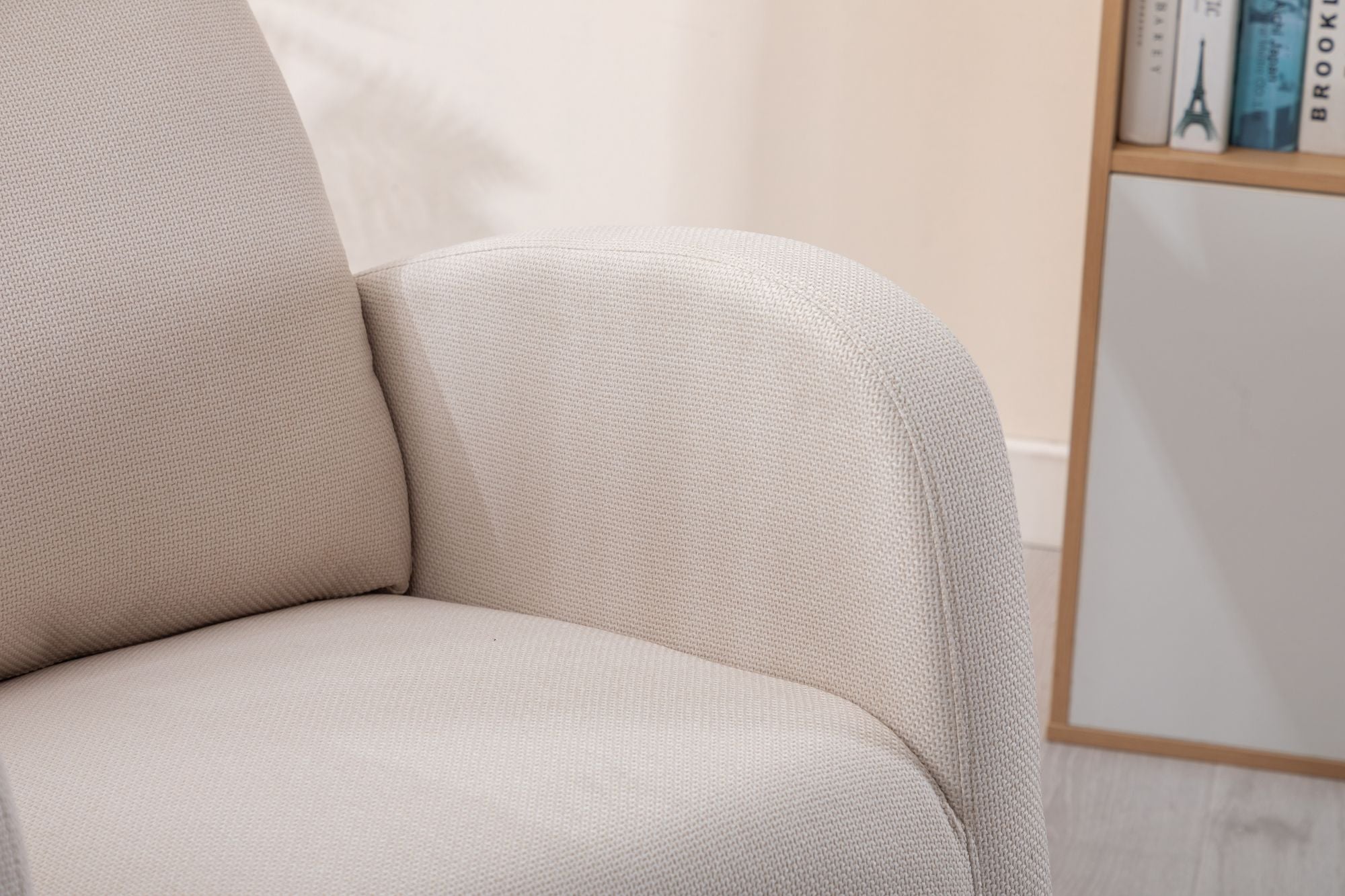 Beige linen COOLMORE rocking chair with padded armrests and high back in a modern living room setting.