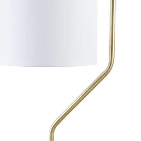 Close-up of gold angular metal stand with white drum shade on an Angular Arched Metal Floor Lamp