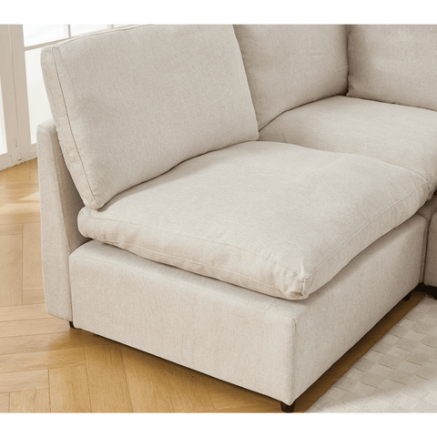 Beige sectional couch with soft linen fabric and cushion back in modern living room setting.