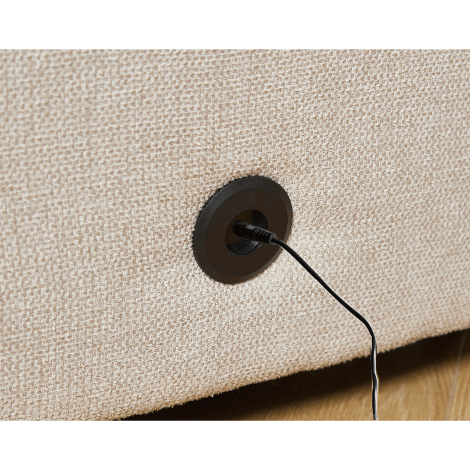 Beige soft linen fabric sectional couch close-up showing built-in wireless charging port on the side panel.
