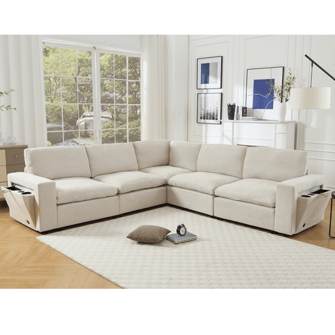 Beige 5-seat modular sectional couch with soft linen fabric, wireless charging ports, cup holders, and book storage in modern living room.