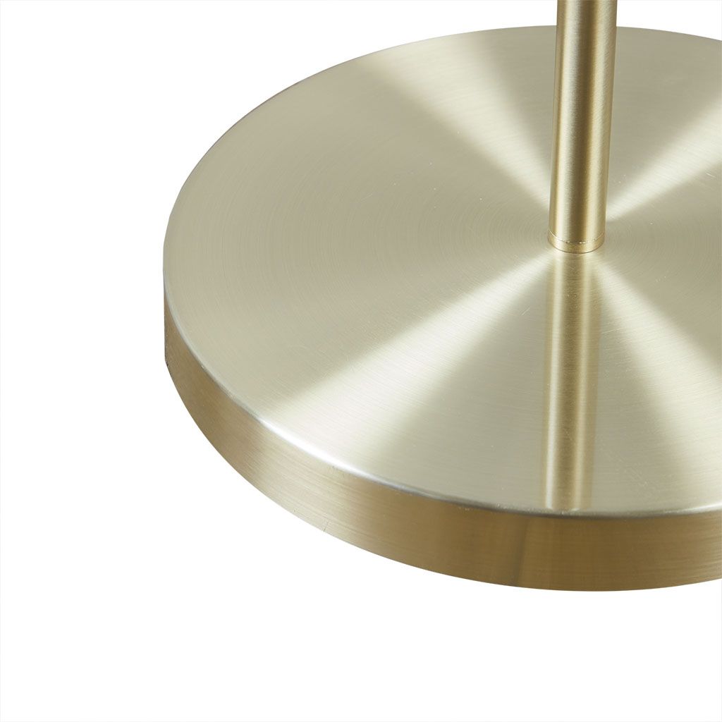 Close-up of gold metal base of Angular Arched Metal Floor Lamp