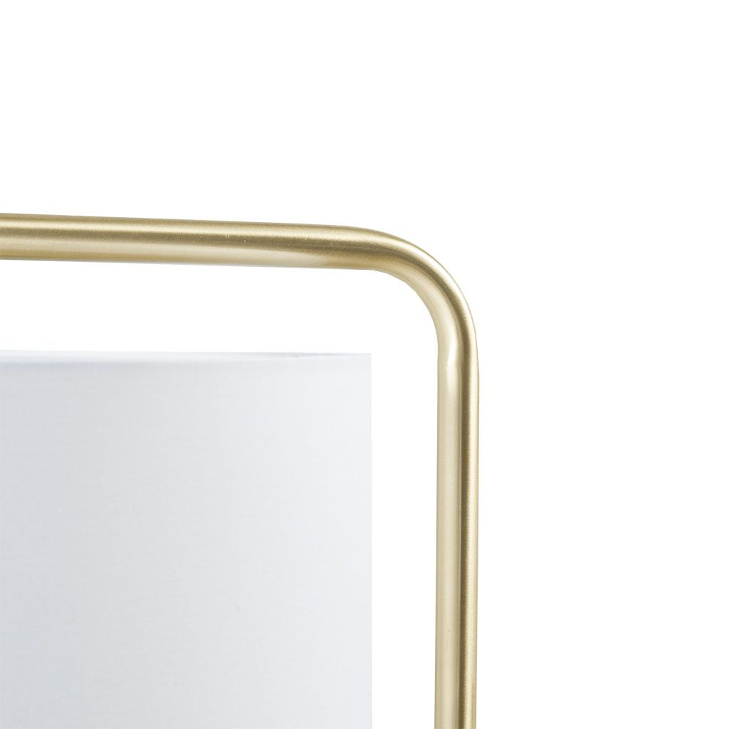 Gold angular arched metal floor lamp with white drum polyester shade and clear cord