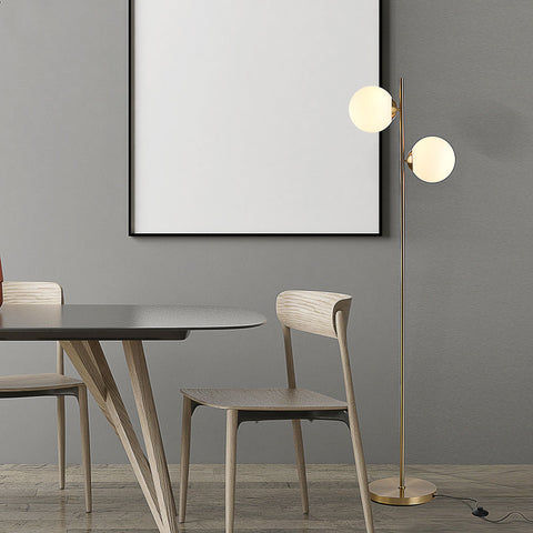 HOMCOM decorative floor lamp with 2 white glass globe shades and gold metal body in modern living room setting