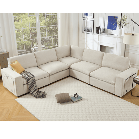 Beige 5-seat modular sectional couch with soft linen fabric, L-shaped design, wireless charging ports, cup holders, and book storage space for living room.